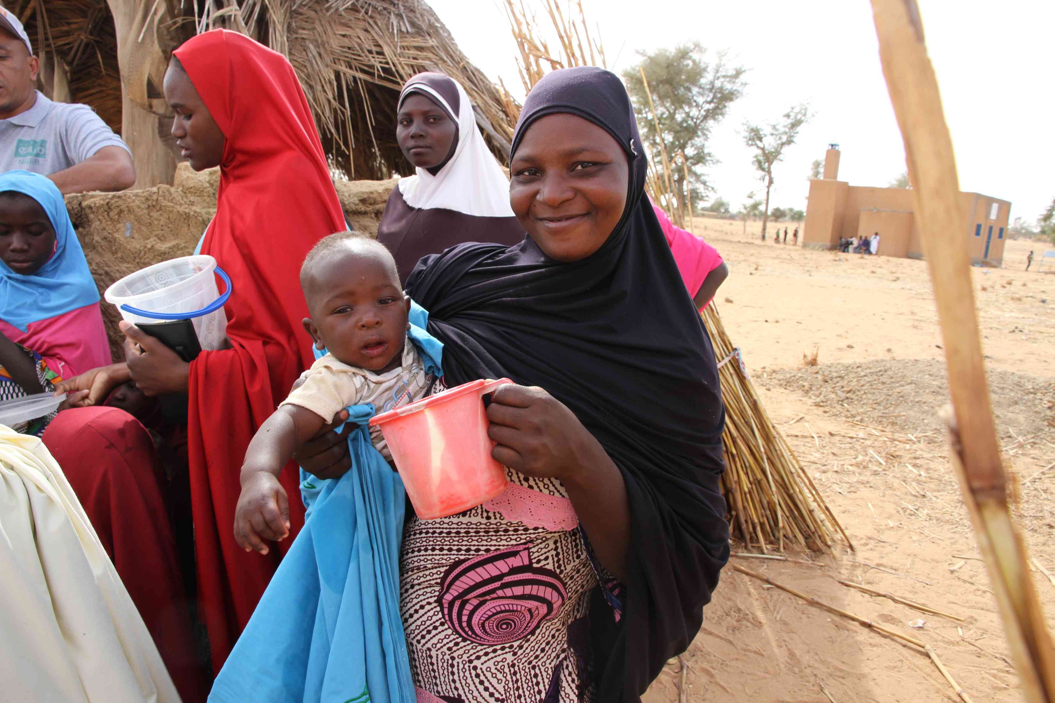 People gathering around a large community well in Africa